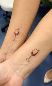Wine glass tattoo placed on the tricep microrealistic